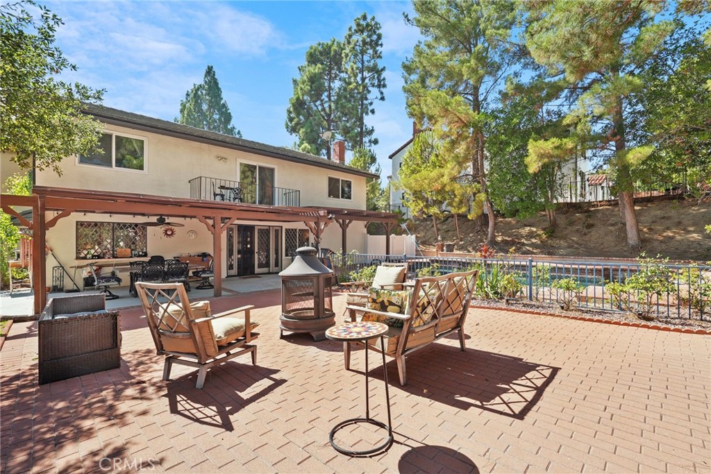 19317 Vista Grande Way Porter Ranch, CA 91326 - Photo 38 of 53 a view of a patio with couches table and chairs and potted plants