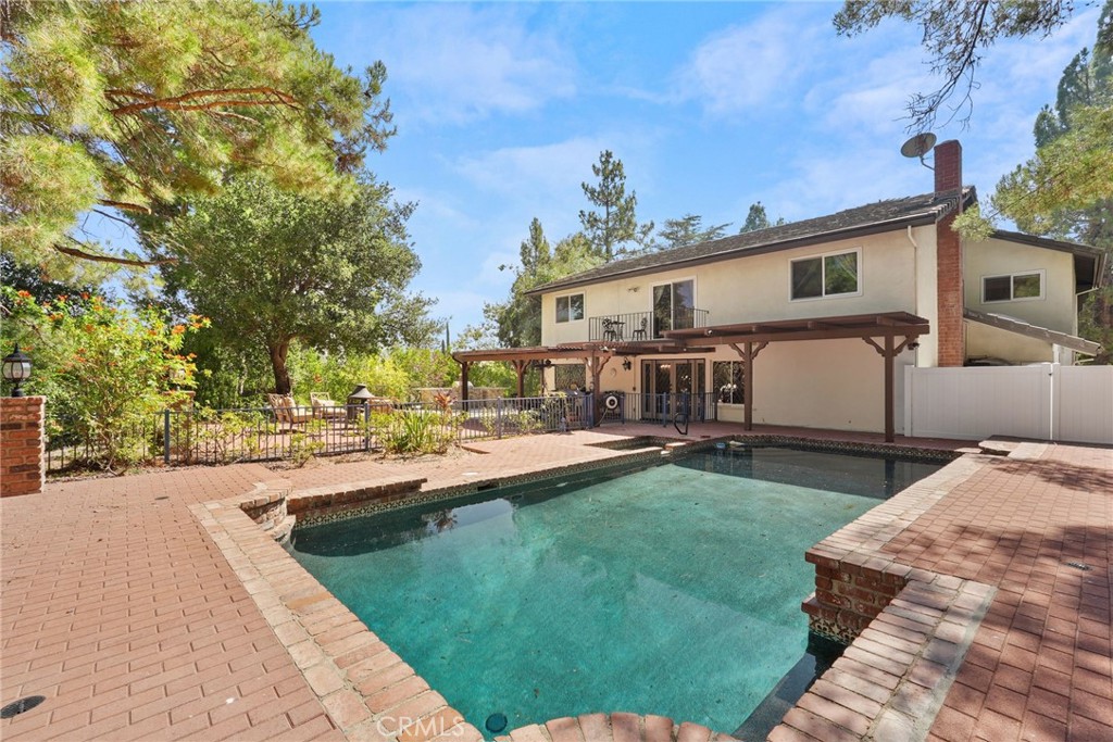 19317 Vista Grande Way Porter Ranch, CA 91326 - Photo 42 of 53 a view of a house with backyard sitting area and swimming pool