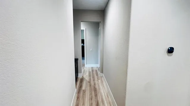 a view of a room with wooden floor
