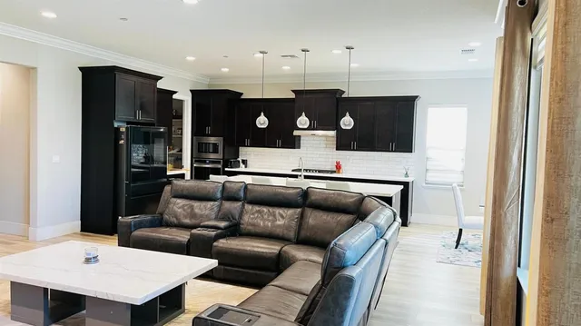 a living room with furniture and kitchen view