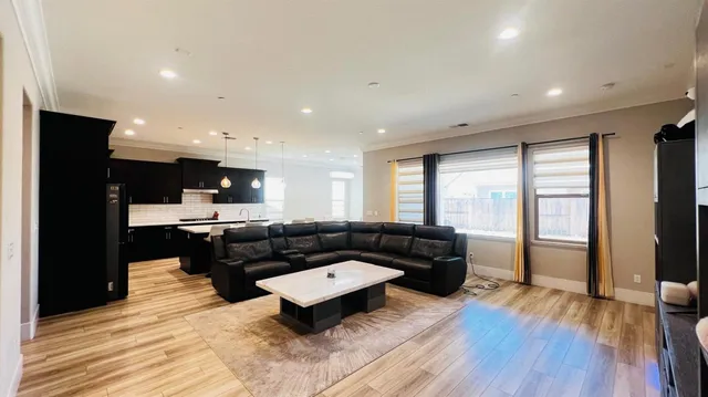 a living room with furniture and a wooden floor