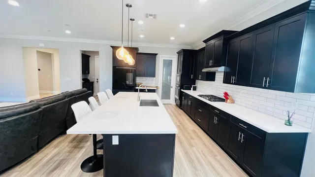 a large kitchen with a table and chairs