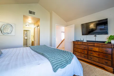 a bedroom with a bed and a flat screen tv