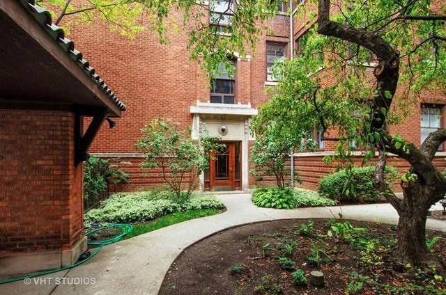a front view of a house with a yard garage and outdoor seating
