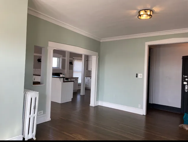 a view of living room with furniture and wooden floor