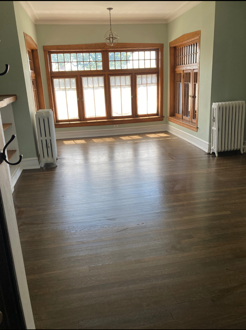 1150 Washington Boulevard, Unit 3 Oak Park, IL 60302 - Photo 5 of 9 a view of an empty room with wooden floor and a window