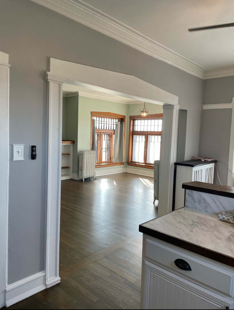 1150 Washington Boulevard, Unit 3 Oak Park, IL 60302 - Photo 8 of 9 a view of a hallway with wooden floor and chandelier