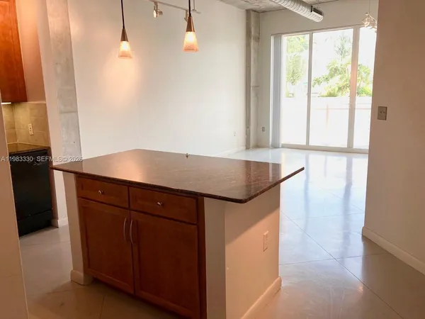 a kitchen with a sink a microwave a stove and refrigerator