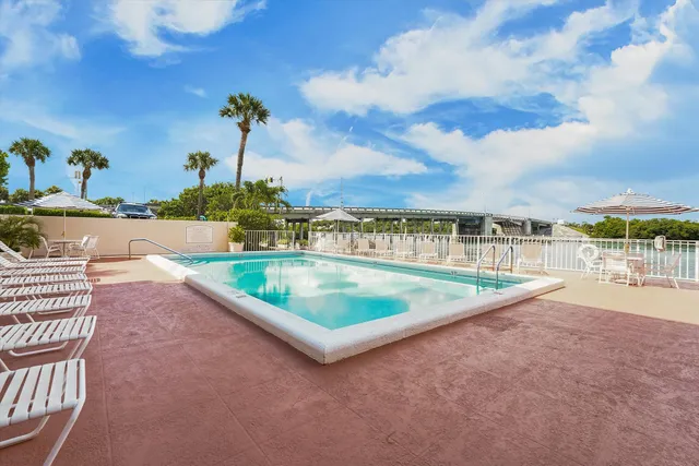 a bedroom with a large bed and a flat tv screen on dresser