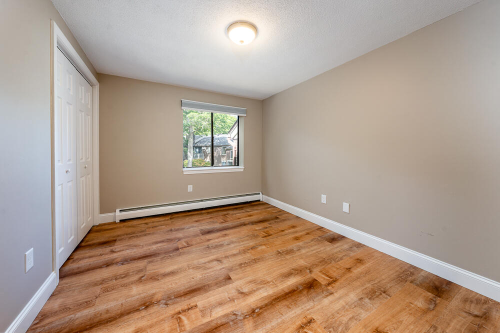 825 West Main Street, Unit 4 Hyannis, MA 02601 - Photo 11 of 20 an empty room with wooden floor and windows