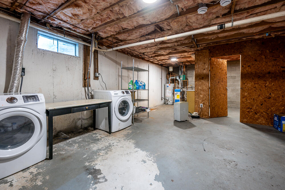 825 West Main Street, Unit 4 Hyannis, MA 02601 - Photo 13 of 20 a view of a storage & utility room with water heater and racks