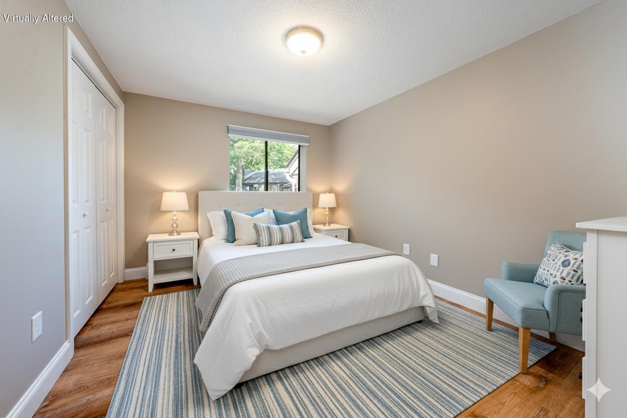825 West Main Street, Unit 4 Hyannis, MA 02601 - Photo 18 of 20 a bedroom with a bed and wooden floor