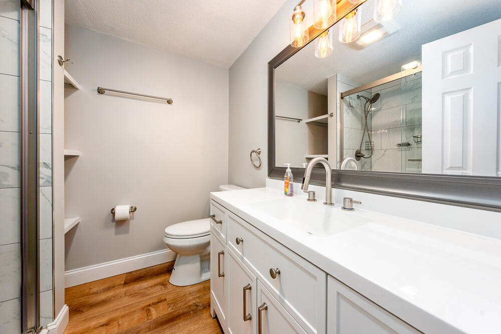 825 West Main Street, Unit 4 Hyannis, MA 02601 - Photo 9 of 20 a bathroom with a sink a toilet a mirror and shower