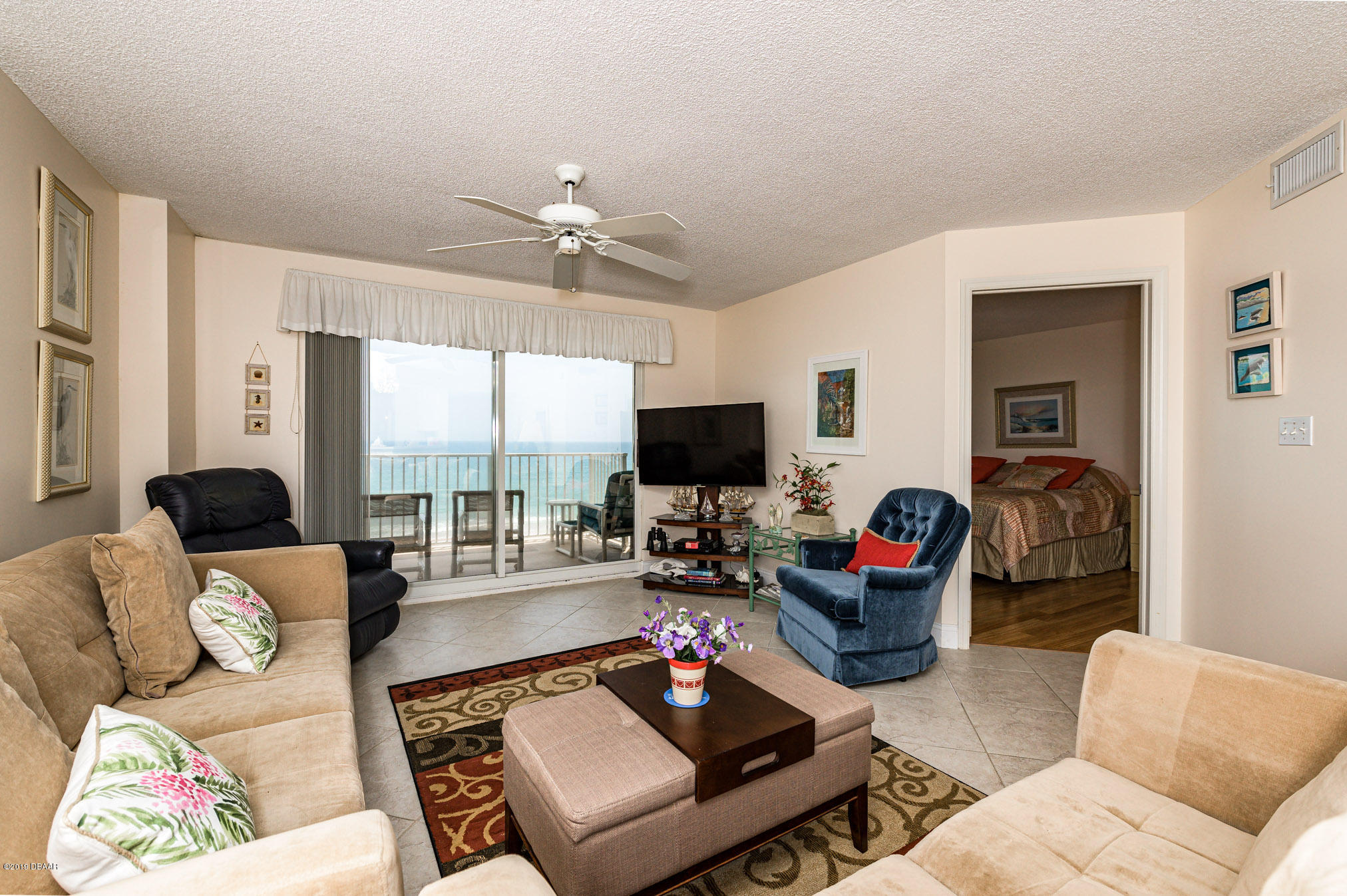1183 Ocean Shore Boulevard, Unit 602 Ormond Beach, FL 32176 - Photo 12 of 27 a living room with furniture fireplace and a flat screen tv