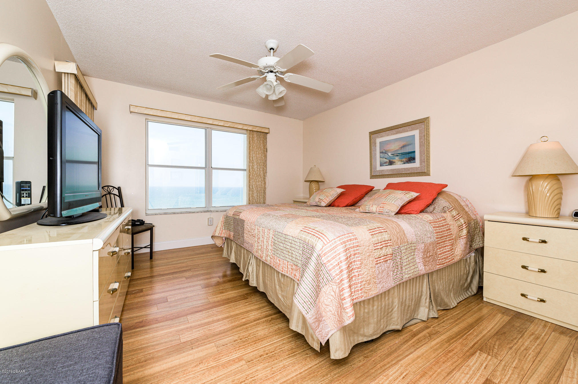 1183 Ocean Shore Boulevard, Unit 602 Ormond Beach, FL 32176 - Photo 13 of 27 a bedroom with a bed and a flat tv screen on dresser
