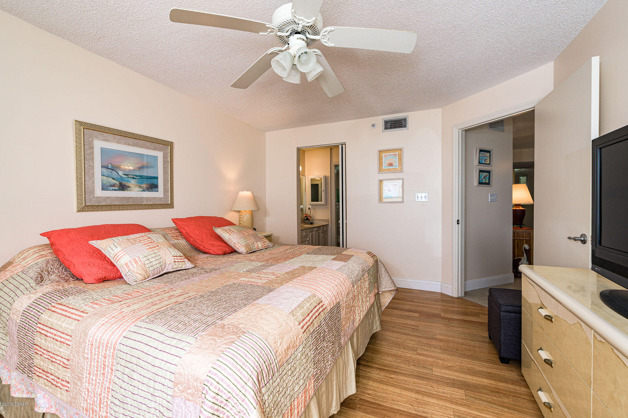 1183 Ocean Shore Boulevard, Unit 602 Ormond Beach, FL 32176 - Photo 14 of 27 a bedroom with a bed and a chandelier