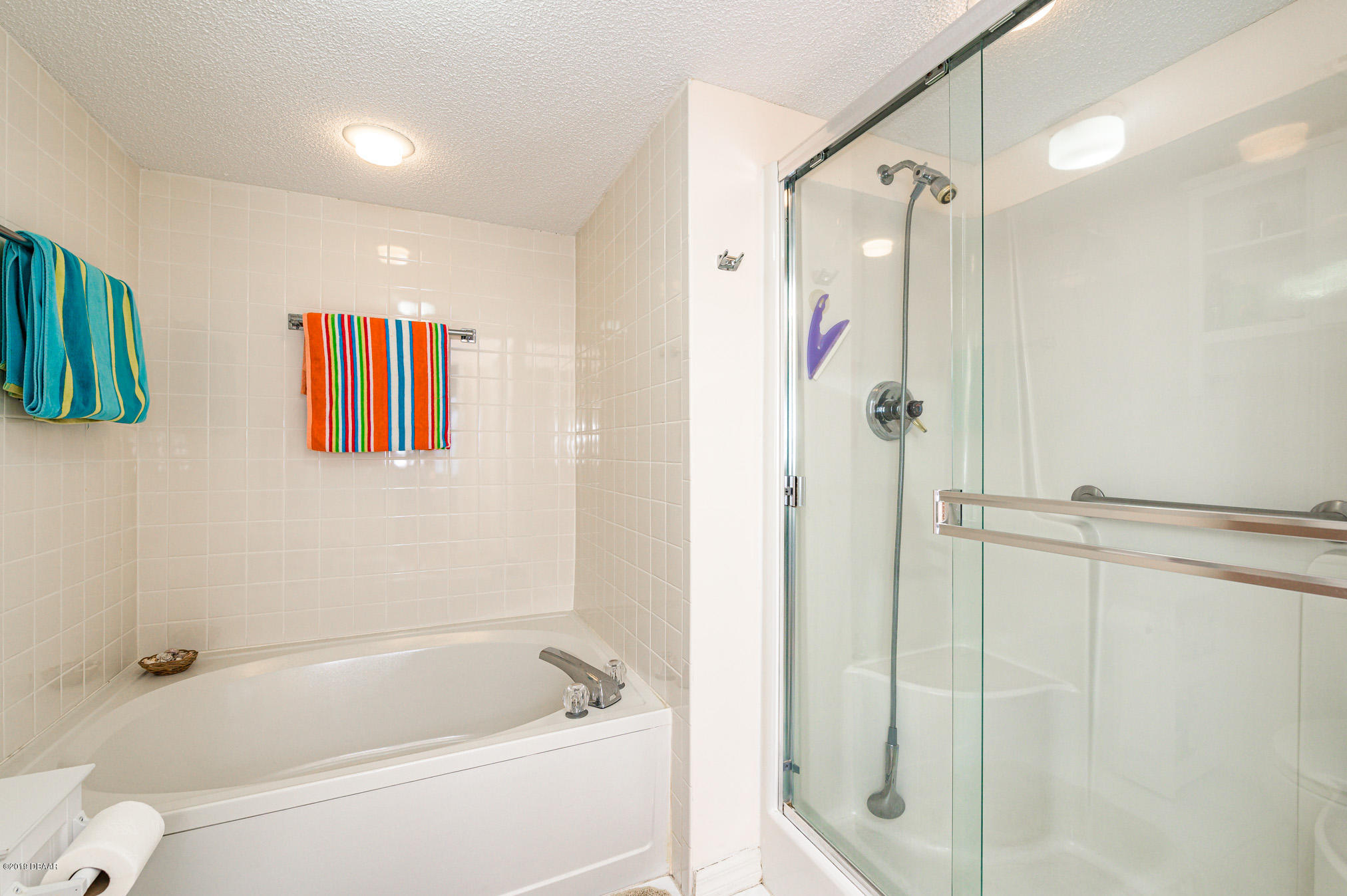 1183 Ocean Shore Boulevard, Unit 602 Ormond Beach, FL 32176 - Photo 16 of 27 a bathroom with a bathtub and a shower