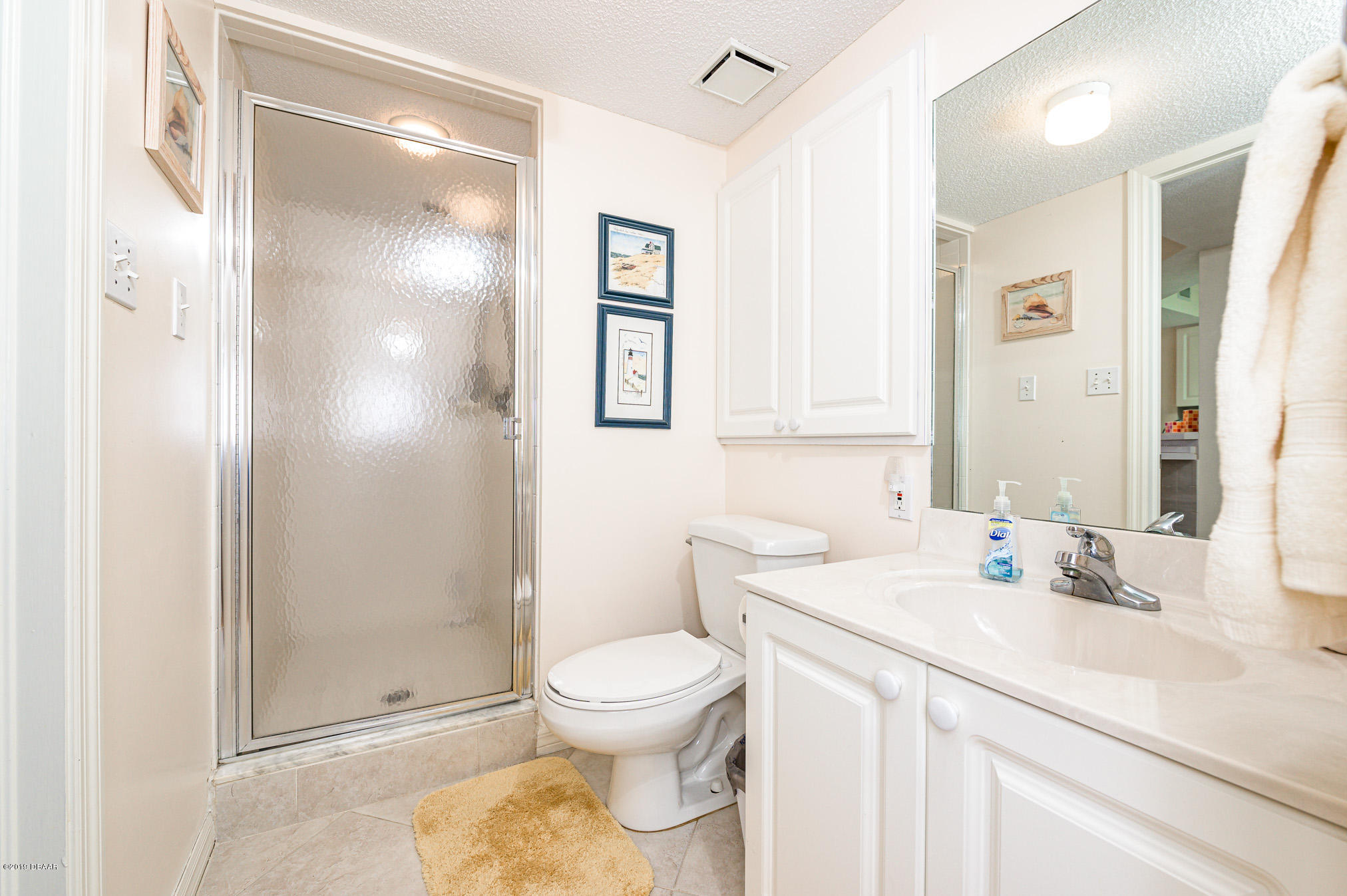 1183 Ocean Shore Boulevard, Unit 602 Ormond Beach, FL 32176 - Photo 17 of 27 a bathroom with a toilet sink and shower