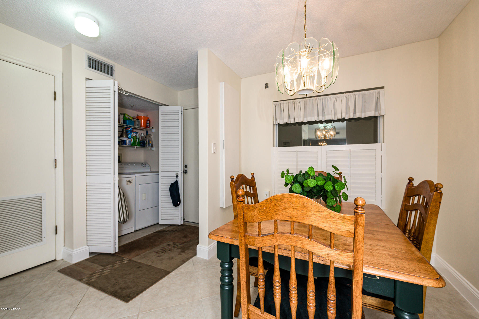 1183 Ocean Shore Boulevard, Unit 602 Ormond Beach, FL 32176 - Photo 4 of 27 a view of a dining room with furniture and chandelier