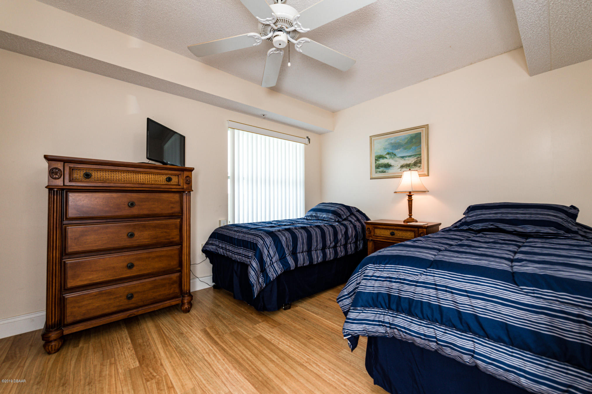 1183 Ocean Shore Boulevard, Unit 602 Ormond Beach, FL 32176 - Photo 7 of 27 a bedroom with two beds and painting on the wall