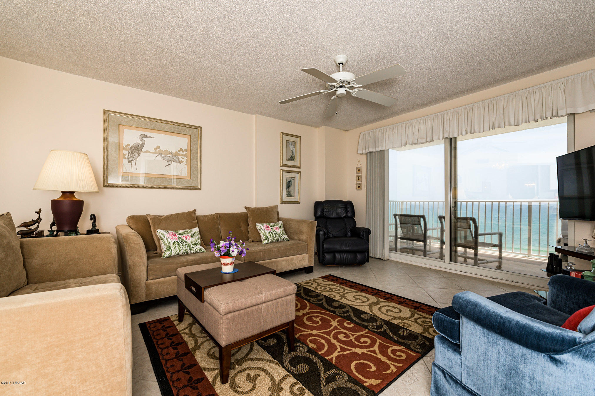 1183 Ocean Shore Boulevard, Unit 602 Ormond Beach, FL 32176 - Photo 10 of 27 a living room with furniture and a floor to ceiling window