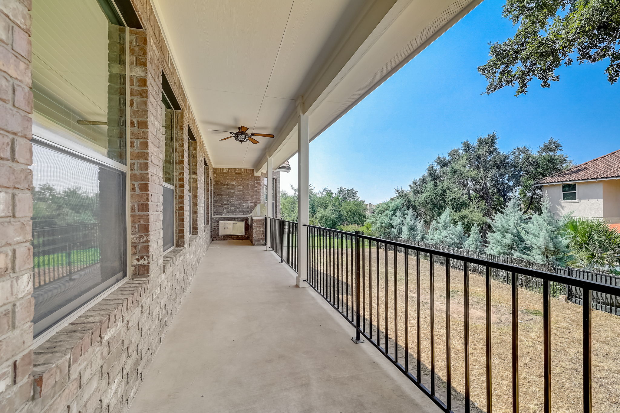 16012 Spillman Ranch Loop Austin, TX 78738 - Photo 31 of 38 A spacious covered patio offers a cool retreat, perfect for enjoying the serene backyard views.