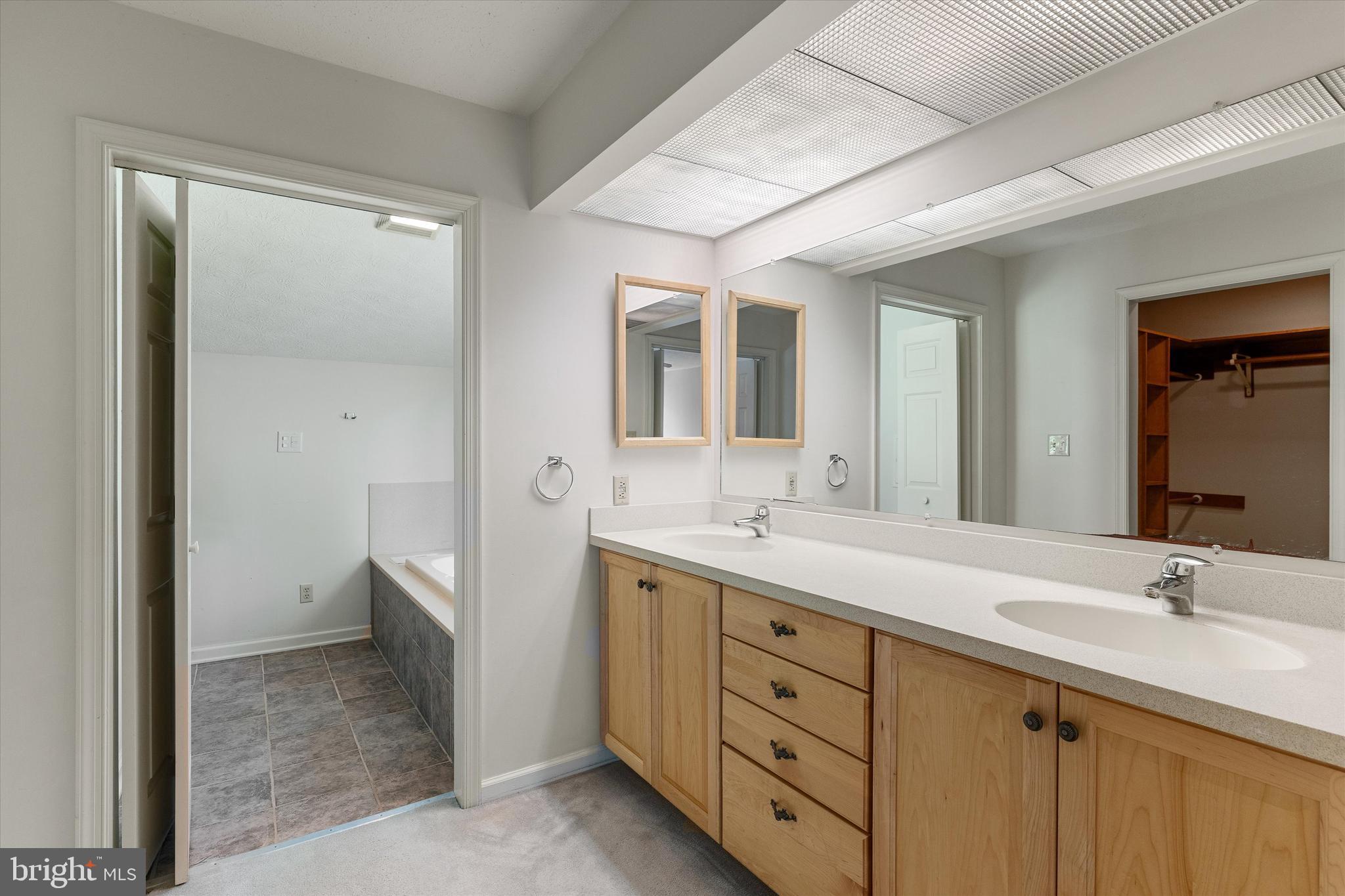 112 Old Forest Circle Winchester, VA 22602 - Photo 32 of 77 a spacious bathroom with a double vanity sink and mirror