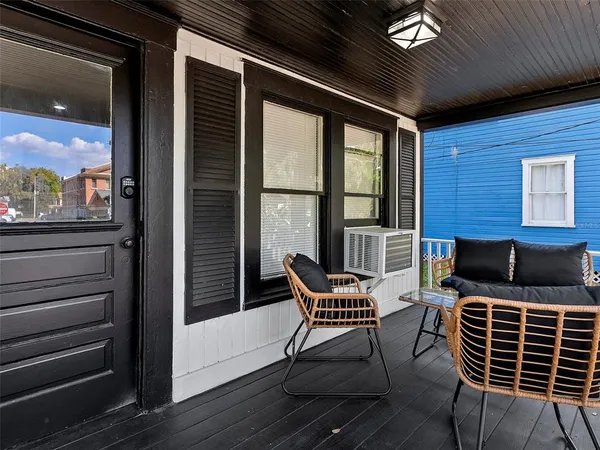 a balcony with table and chairs