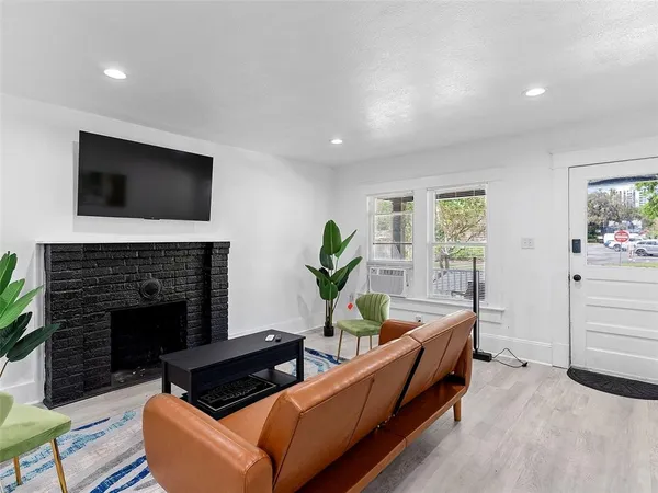 a living room with furniture and a fireplace