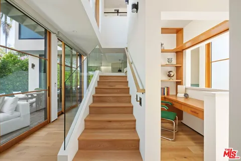 a view of entryway and hall with wooden floor