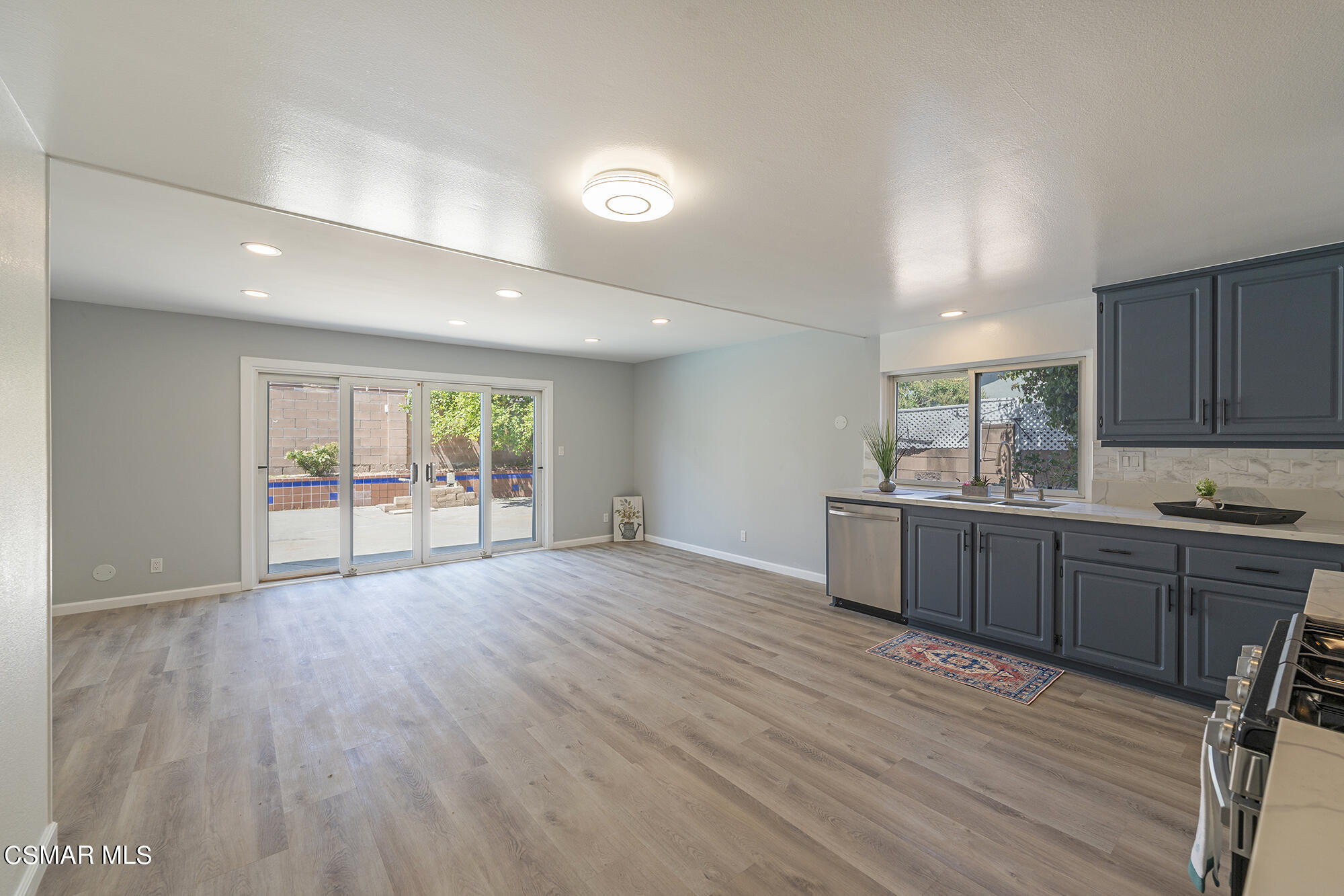 2305 Cochran Street Simi Valley, CA 93065 - Photo 13 of 43 a kitchen with stainless steel appliances granite countertop a stove cabinets and wooden floor