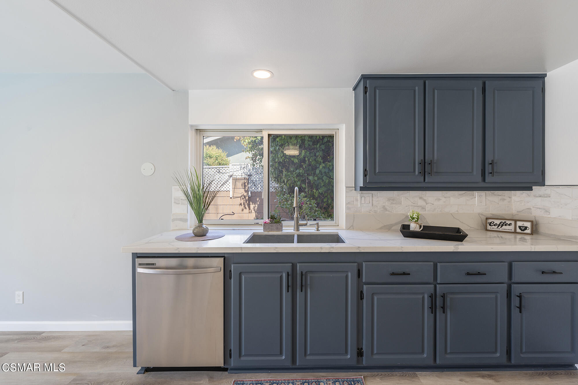 2305 Cochran Street Simi Valley, CA 93065 - Photo 14 of 43 a kitchen with a sink and cabinets