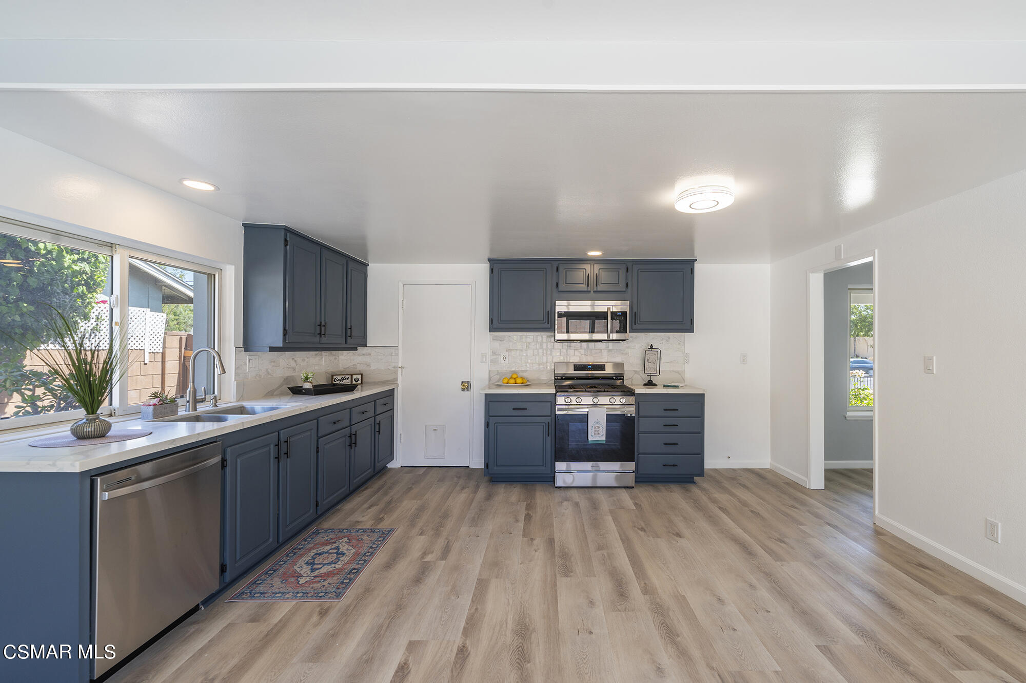 2305 Cochran Street Simi Valley, CA 93065 - Photo 18 of 43 a large kitchen with stainless steel appliances lots of counter space and wooden floor