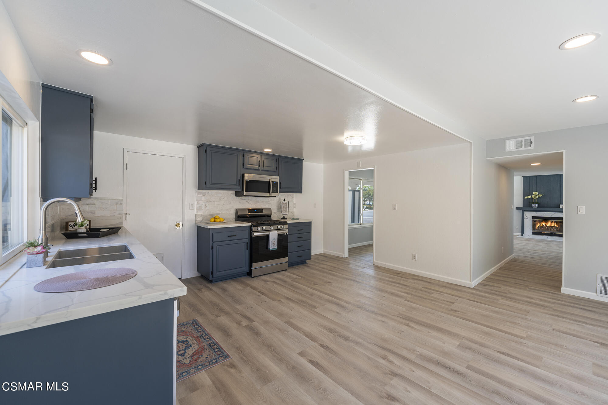 2305 Cochran Street Simi Valley, CA 93065 - Photo 19 of 43 a kitchen with stainless steel appliances kitchen island granite countertop a stove a sink and a refrigerator