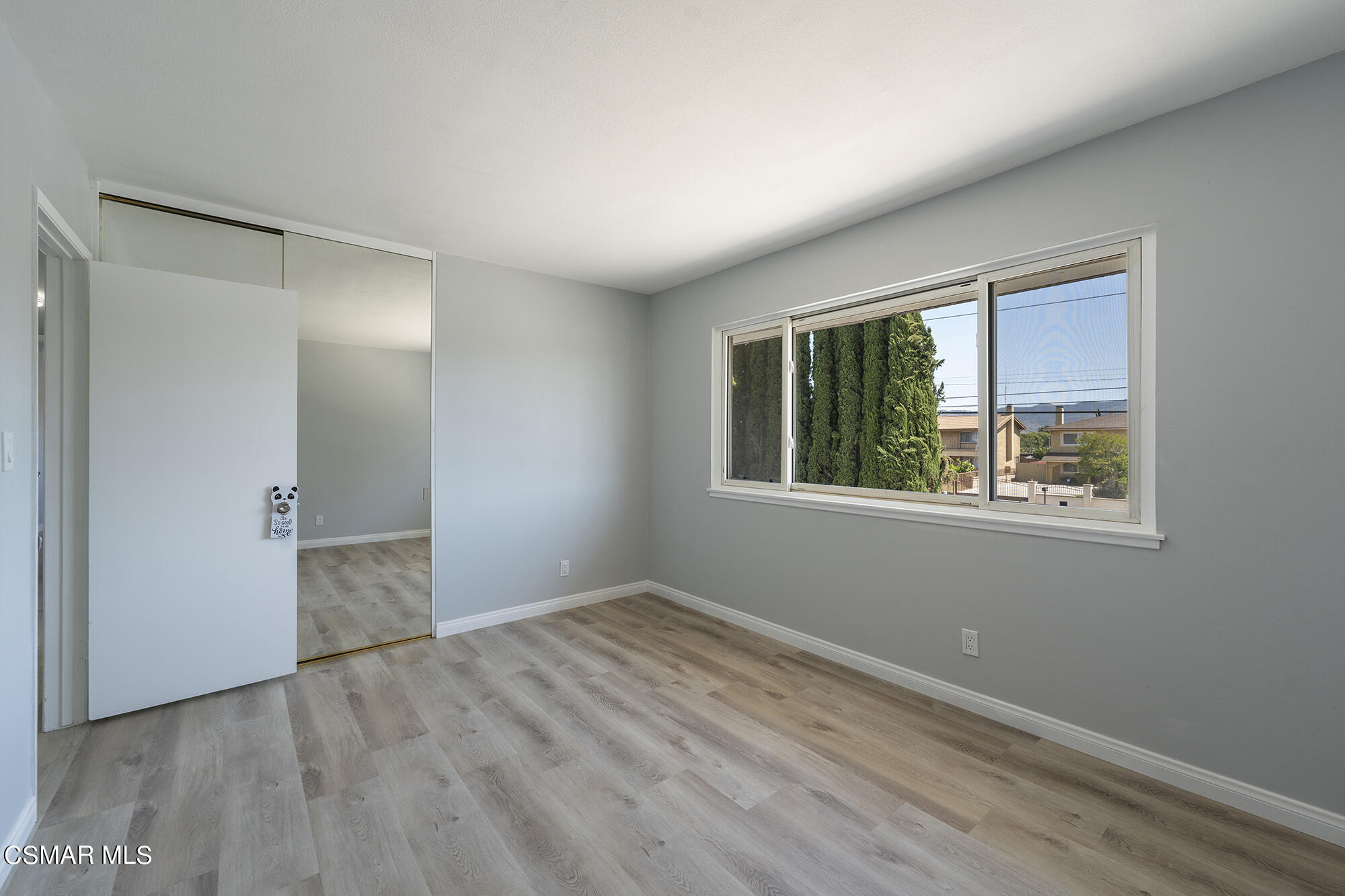 2305 Cochran Street Simi Valley, CA 93065 - Photo 25 of 43 a view of an empty room with wooden floor and a window