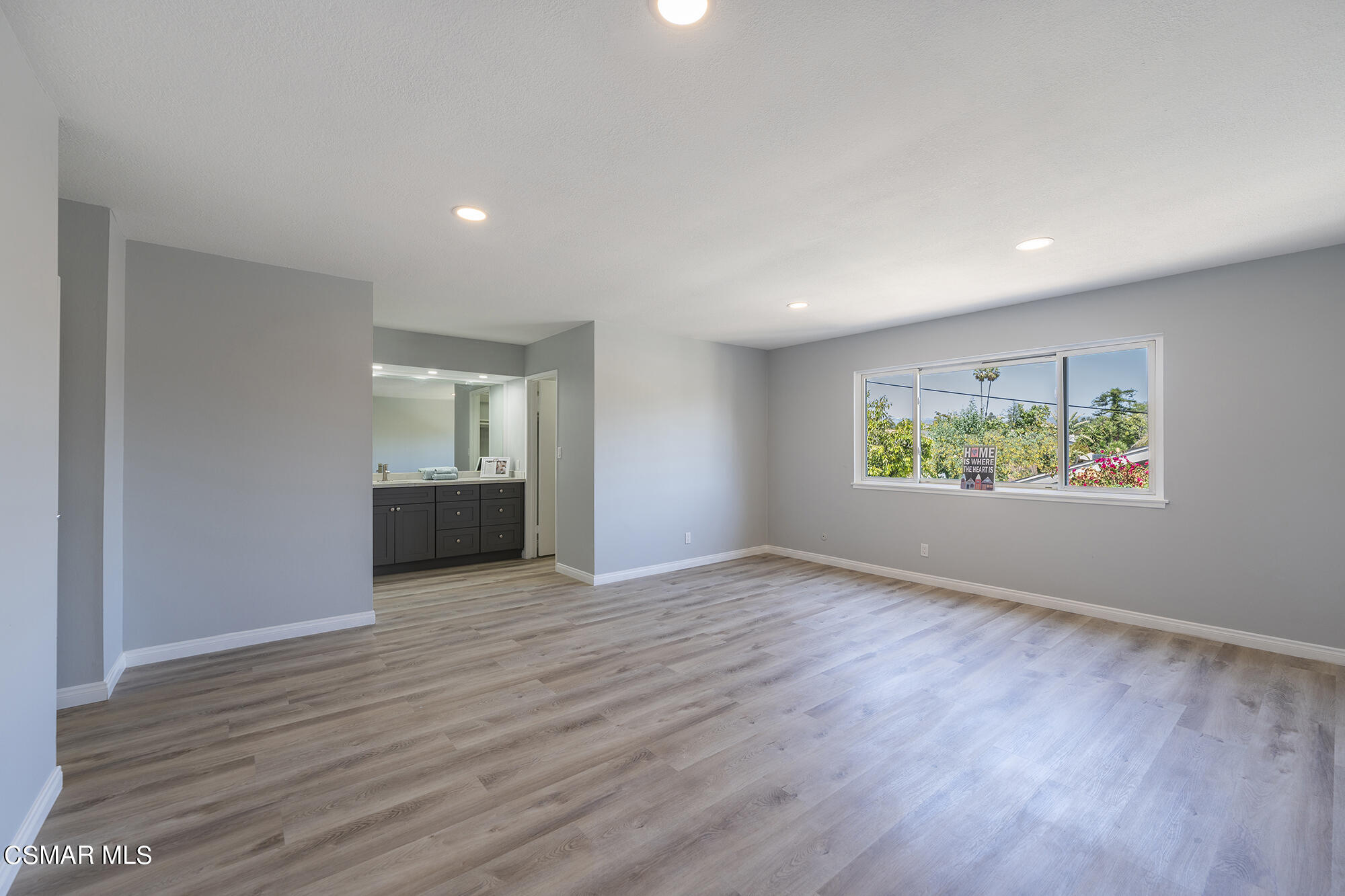 2305 Cochran Street Simi Valley, CA 93065 - Photo 29 of 43 a view of an empty room with wooden floor and a window