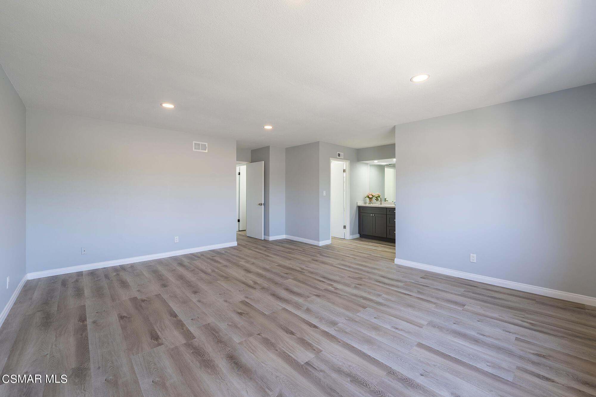 2305 Cochran Street Simi Valley, CA 93065 - Photo 30 of 43 a view of an empty room with wooden floor and a window