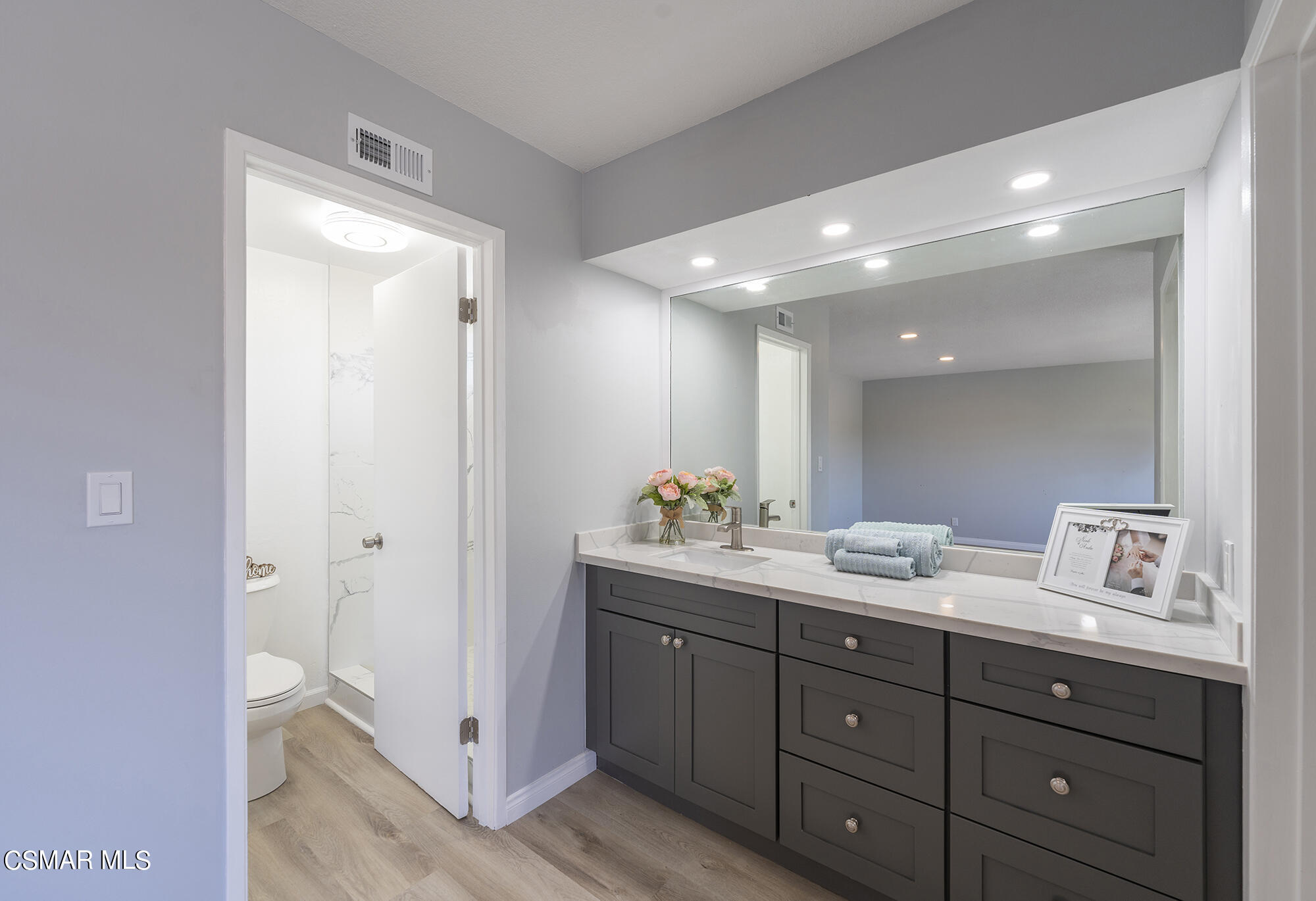 2305 Cochran Street Simi Valley, CA 93065 - Photo 32 of 43 a bathroom with a double vanity sink and mirror with shower