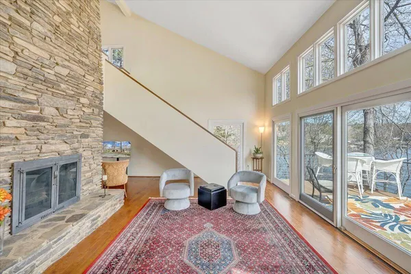 a view of a house with pool and chairs