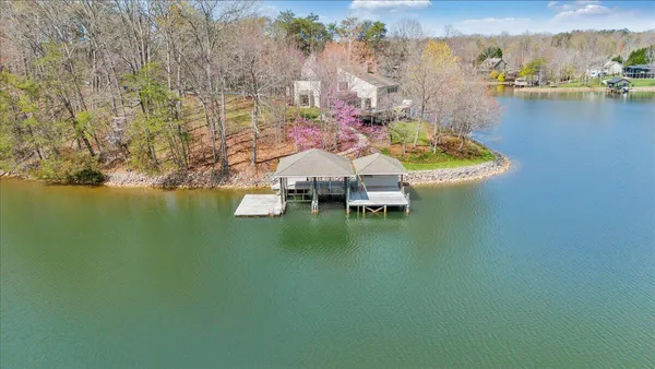 a room with stainless steel appliances kitchen island granite countertop furniture and a view of living room