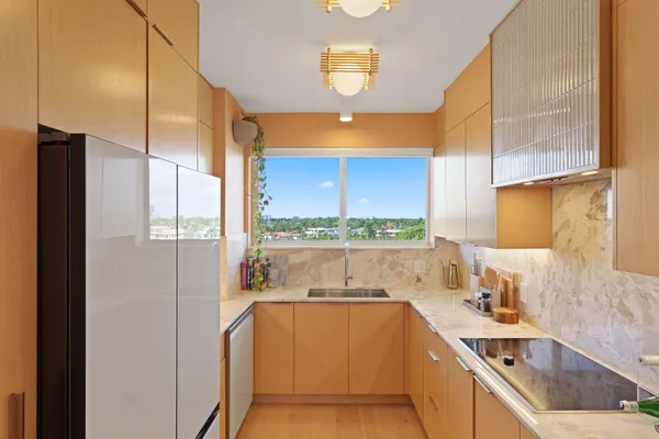 a view of a kitchen with a large window