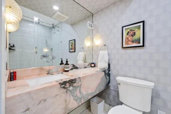 a bathroom with a shower a toilet and a shower