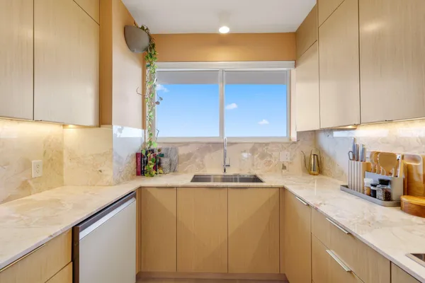 a kitchen with a sink a cabinets and window