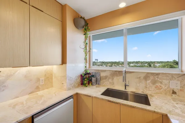 a kitchen with a sink a counter top space and a granite counter top