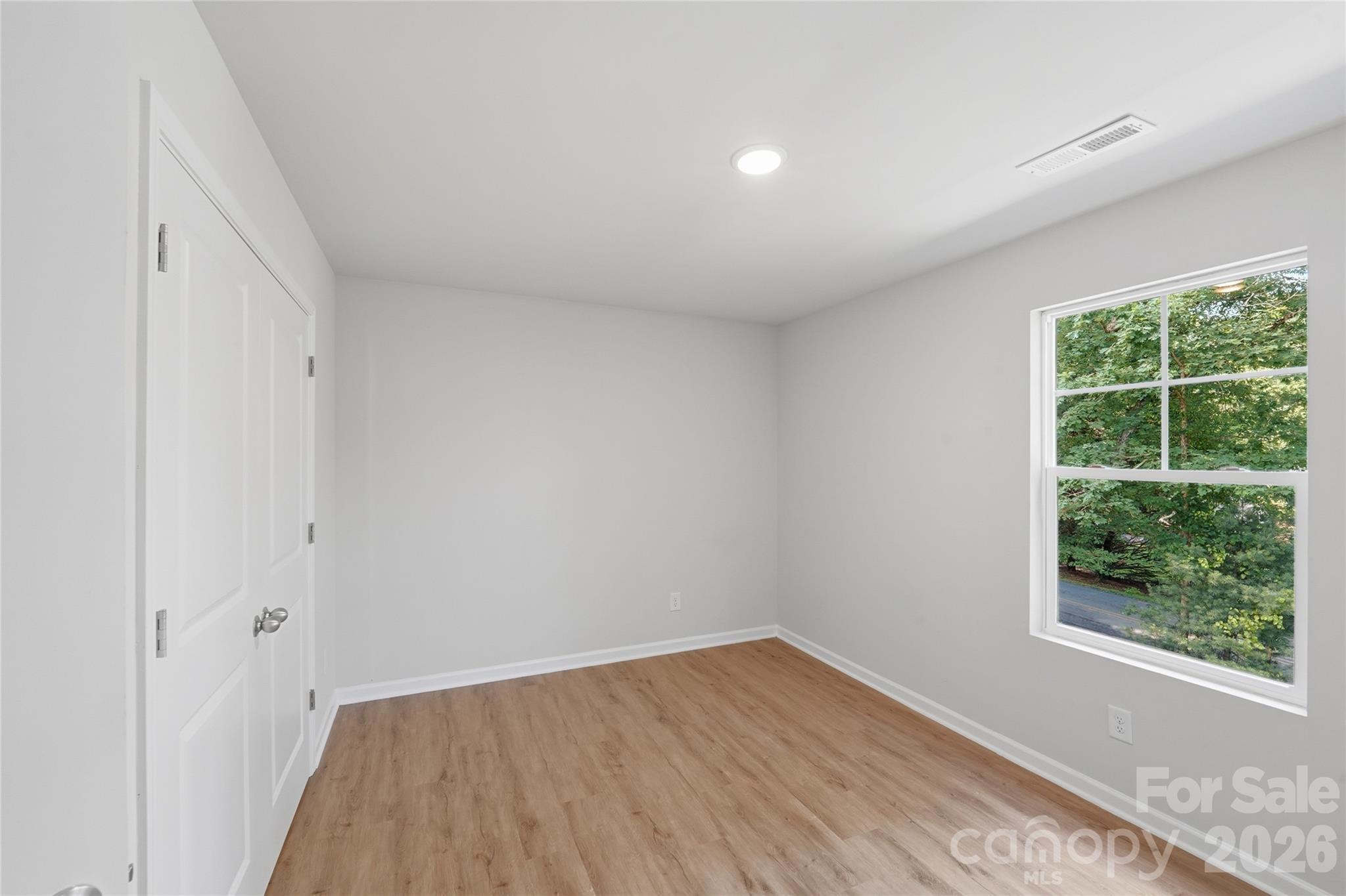 242 Landers Chapel Road Lincolnton, NC 28092 - Photo 21 of 33 a view of an empty room with wooden floor and a window