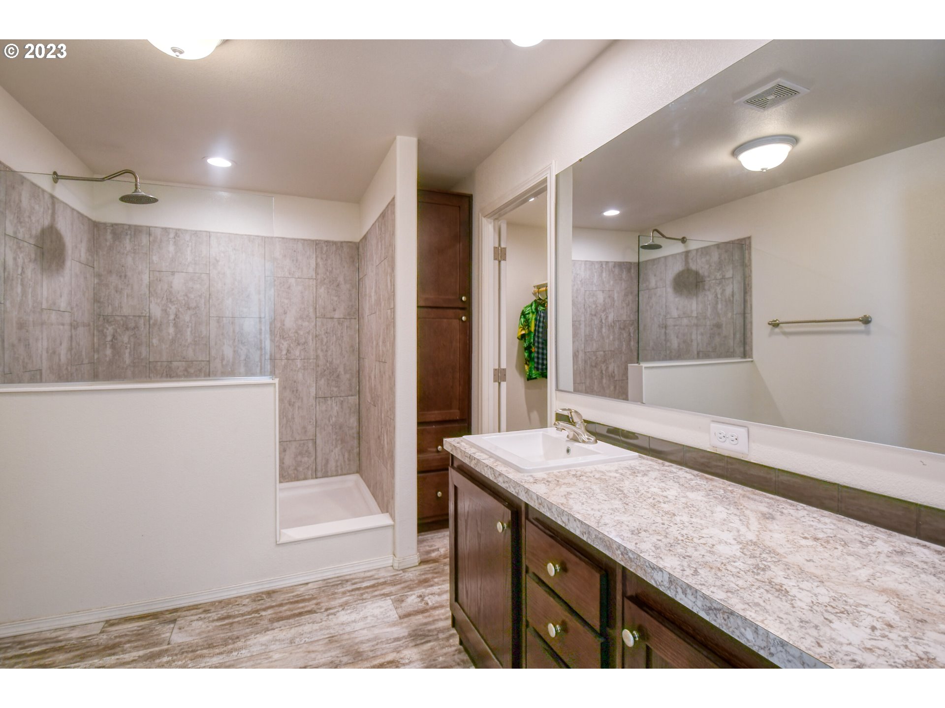 301 Northwest 3rd Street Boardman, OR 97818 - Photo 14 of 31 a bathroom with a granite countertop sink a toilet a mirror and shower