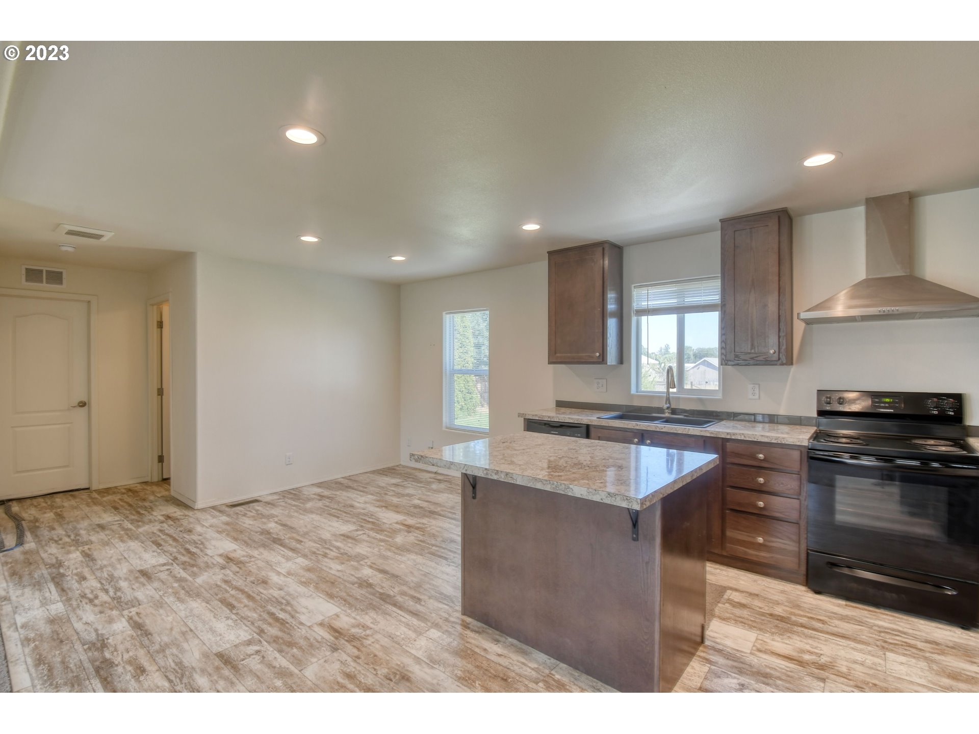 301 Northwest 3rd Street Boardman, OR 97818 - Photo 20 of 31 a kitchen with stainless steel appliances granite countertop a sink stove and refrigerator