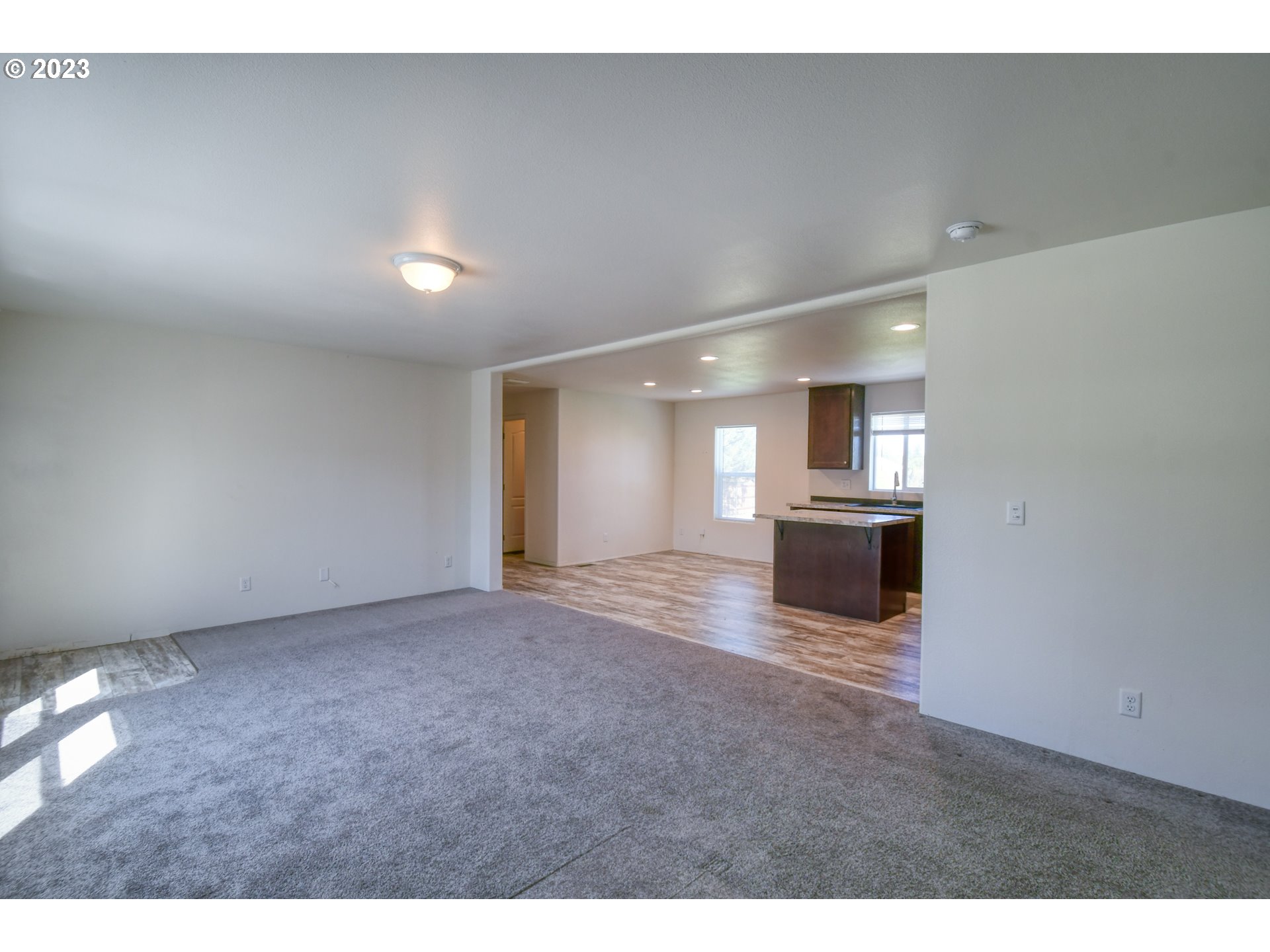 301 Northwest 3rd Street Boardman, OR 97818 - Photo 6 of 31 a view of empty room with a kitchen