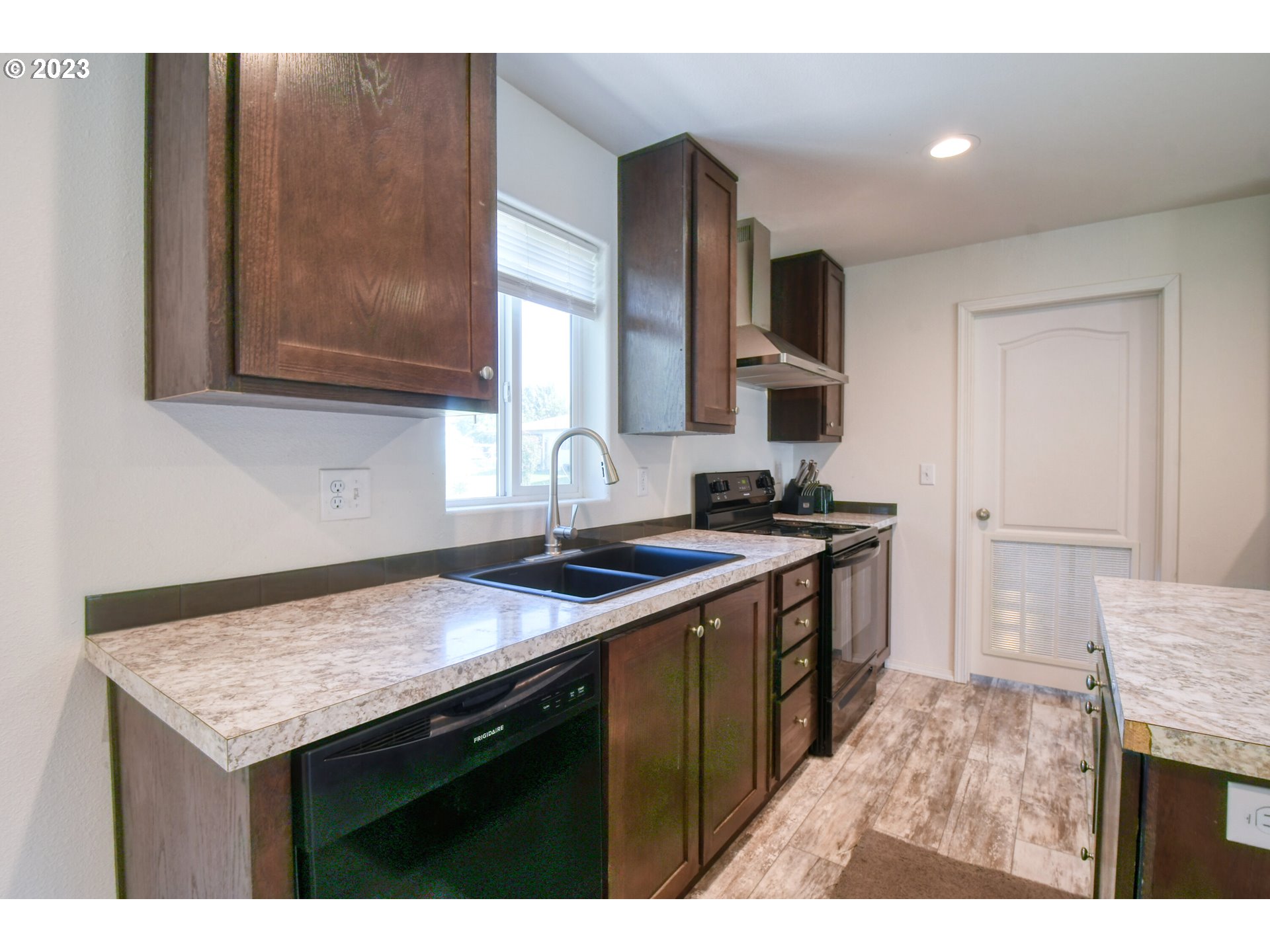 301 Northwest 3rd Street Boardman, OR 97818 - Photo 9 of 31 a kitchen with a sink stove and refrigerator