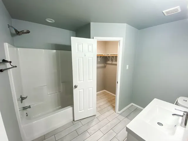 a bathroom with a shower and mirror